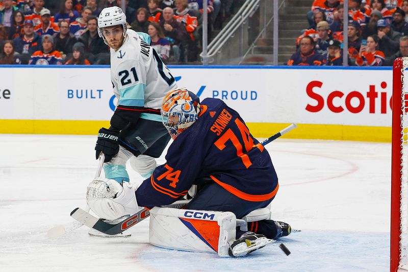 Jan 18, 2024; Edmonton, Alberta, CAN; Edmonton Oilers goaltender Stuart Skinner (74) makes a save on a deflection by Seattle Kraken forward Alex Weinberg (21) during the second period at Rogers Place. Mandatory Credit: Perry Nelson-USA TODAY Sports