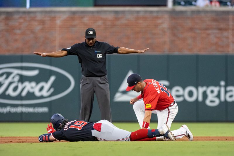 Aug 23, 2024; Cumberland, Georgia, USA; Washington Nationals third base Andres Chaparro (19) slides into second base against Atlanta Braves outfielder Whit Merrifield (15) during the fourth inning at Truist Park. Mandatory Credit: Jordan Godfree-USA TODAY Sports