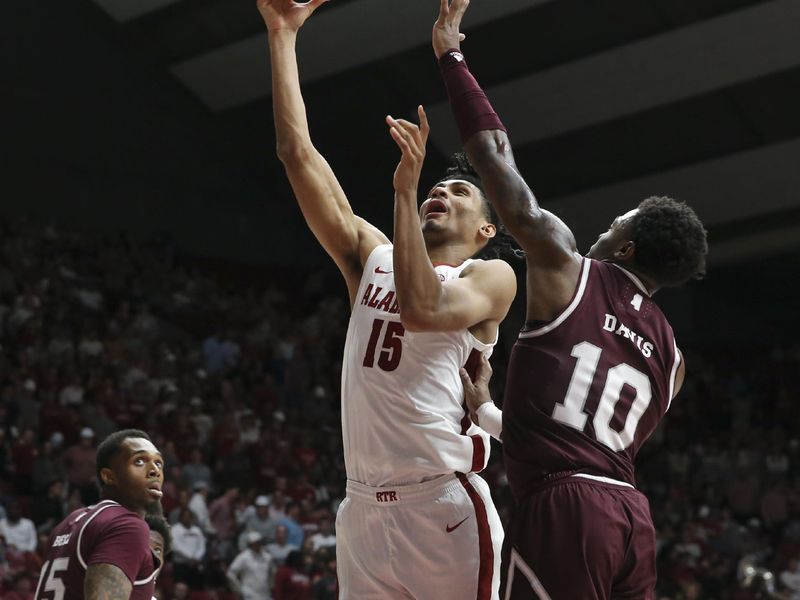 Feb 3, 2024; Tuscaloosa, Alabama, USA;  Alabama forward Jarin Stevenson (15) scores in the lane with Mississippi State guard Dashawn Davis (10) defending at Coleman Coliseum. Mandatory Credit: Gary Cosby Jr.-USA TODAY Sports