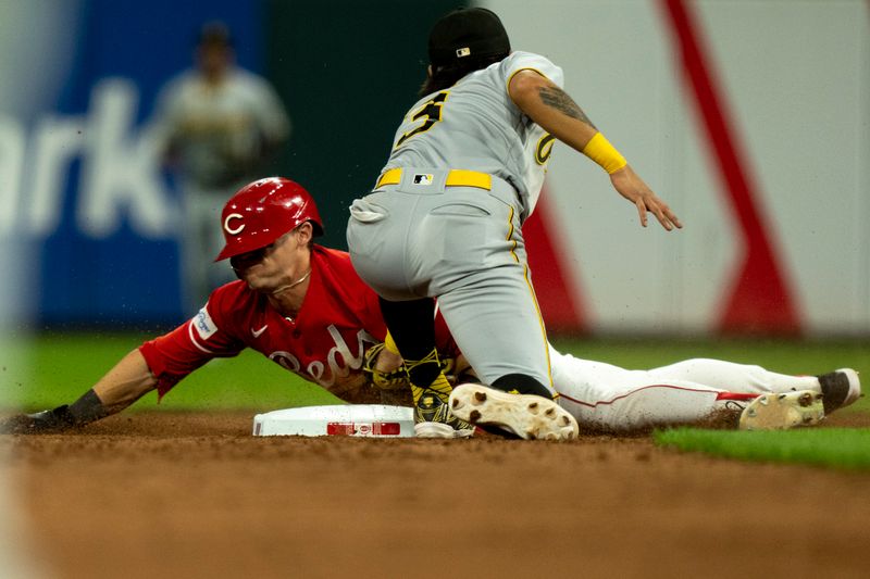 Sep 23, 2023; Cincinnati, Ohio, USA;  Cincinnati Reds center fielder TJ Friedl (29) steals second as Pittsburgh Pirates second baseman Ji Hwan Bae (3) attempts to tag him in the seventh inning at Great American Ball Park. Mandatory Credit: The Cincinnati Enquirer-USA TODAY Sports