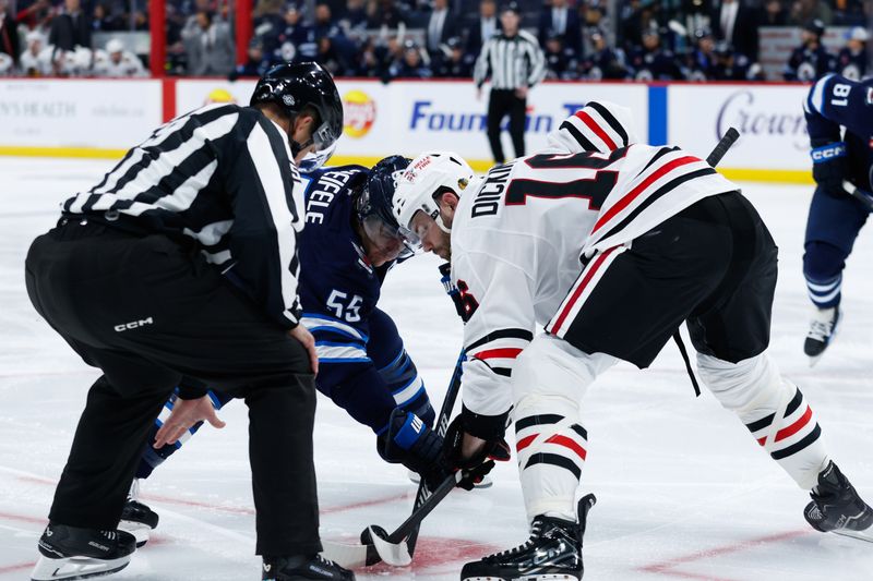 Oct 11, 2024; Winnipeg, Manitoba, CAN;  Winnipeg Jets forward Mark Scheifele (55) faces off against Chicago Blackhawks forward Jason Dickinson (16) during the second period at Canada Life Centre. Mandatory Credit: Terrence Lee-Imagn Images