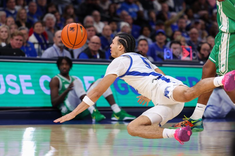 Dec 31, 2025; Memphis, Tennessee, USA; Memphis Tigers guard Curtis Givens III (5) dives for a loose ball against the North Texas Mean Green during the first half at FedExForum. Mandatory Credit: Wesley Hale-Imagn Images