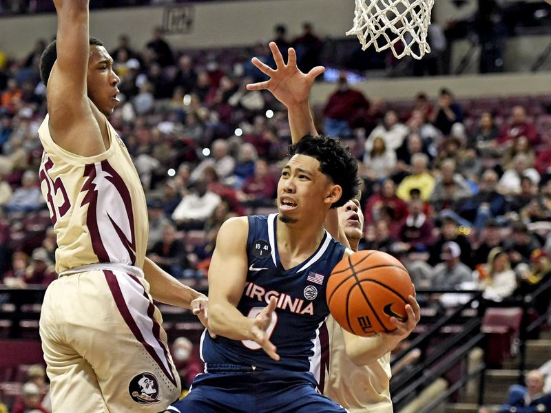 Jan 14, 2023; Tallahassee, Florida, USA; Virginia Cavaliers guard Kihei Clark (0) passes the ball against the defense of the Florida State Seminoles during the first half at Donald L. Tucker Center. Mandatory Credit: Melina Myers-USA TODAY Sports