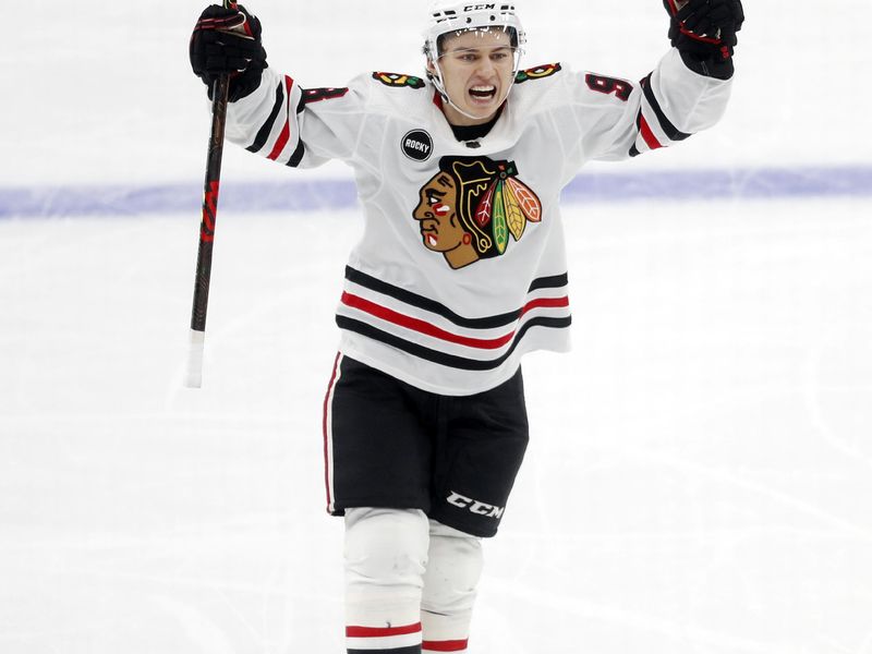 Oct 10, 2023; Pittsburgh, Pennsylvania, USA; Chicago Blackhawks center Connor Bedard (98) reacts to a goal by center Ryan Donato (not pictured) against the Pittsburgh Penguins during the second period at the PPG Paints Arena. Beard assisted on the goal to record his first NHL point in his league debut. Mandatory Credit: Charles LeClaire-USA TODAY Sports