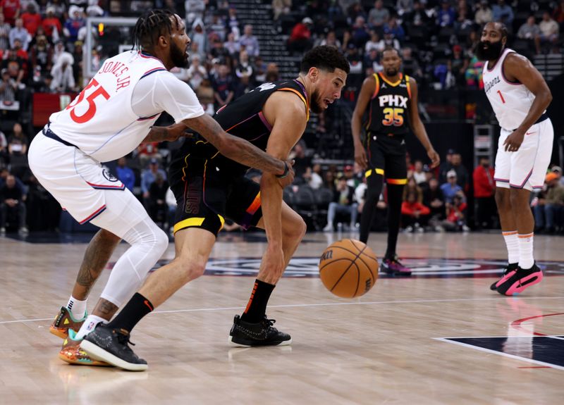 INGLEWOOD, CALIFORNIA - OCTOBER 31: Devin Booker #1 of the Phoenix Suns reacts as he is fouled by Derrick Jones Jr. #55 of the LA Clippers during the first half at Intuit Dome on October 31, 2024 in Inglewood, California. (Photo by Harry How/Getty Images) NOTE TO USER: User expressly acknowledges and agrees that, by downloading and or using this photograph, User is consenting to the terms and conditions of the Getty Images License Agreement.  (Photo by Harry How/Getty Images)