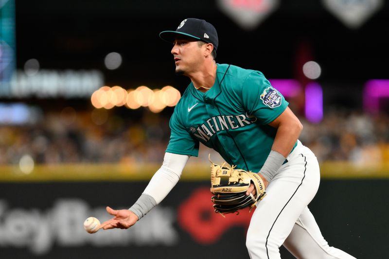 Aug 12, 2023; Seattle, Washington, USA; Seattle Mariners second baseman Josh Rojas (4) throws the ball to first base for the force out on Baltimore Orioles second baseman Adam Frazier (12) during the eighth inning at T-Mobile Park. Mandatory Credit: Steven Bisig-USA TODAY Sports