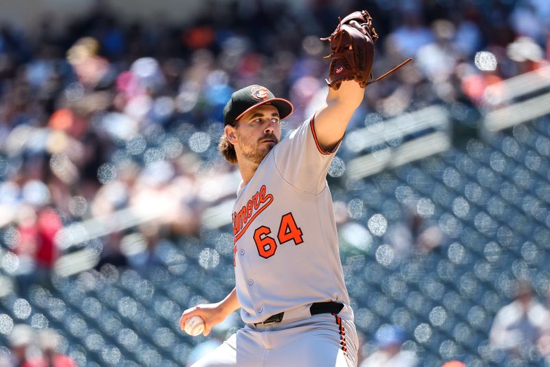 May 8, 2025; Minneapolis, Minnesota, USA; Baltimore Orioles starting pitcher Dean Kremer (64) delivers a pitch against the Minnesota Twins during the first inning at Target Field. Mandatory Credit: Matt Krohn-Imagn Images