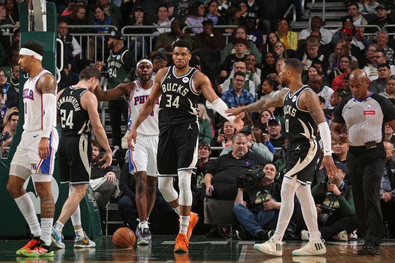 MILWAUKEE, WI - MARCH 14: Giannis Antetokounmpo #34 of the Milwaukee Bucks high fives Damian Lillard #0 during the game against the Philadelphia 76ers on March 14, 2024 at the Fiserv Forum Center in Milwaukee, Wisconsin. NOTE TO USER: User expressly acknowledges and agrees that, by downloading and or using this Photograph, user is consenting to the terms and conditions of the Getty Images License Agreement. Mandatory Copyright Notice: Copyright 2024 NBAE (Photo by Gary Dineen/NBAE via Getty Images).