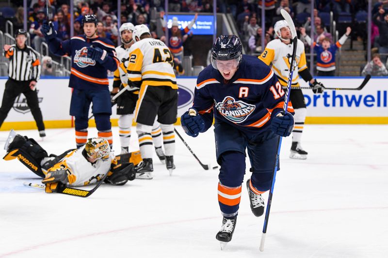 Dec 27, 2022; Elmont, New York, USA; New York Islanders right wing Josh Bailey (12) celebrates his goal against the Pittsburgh Penguins during the second period at UBS Arena. Mandatory Credit: Dennis Schneidler-USA TODAY Sports