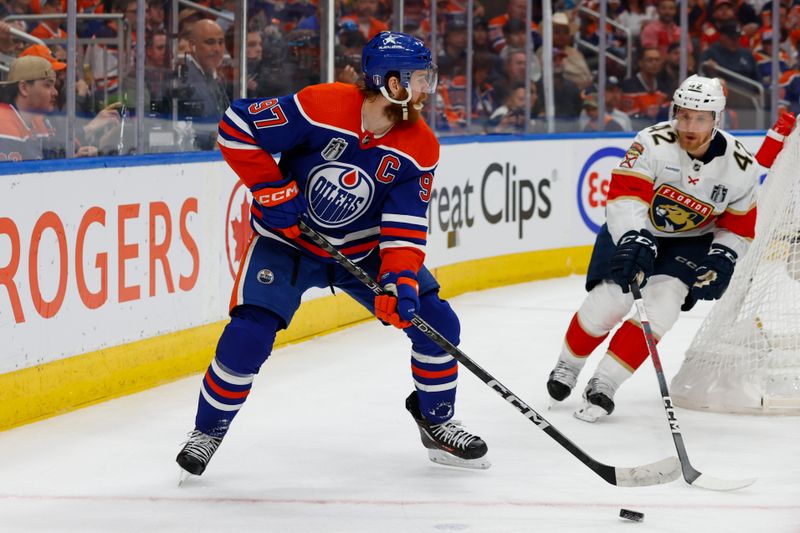 Jun 15, 2024; Edmonton, Alberta, CAN; Edmonton Oilers center Connor McDavid (97) skates with the puck defended by Florida Panthers defenseman Gustav Forsling (42) in the second period in game four of the 2024 Stanley Cup Final at Rogers Place. Mandatory Credit: Perry Nelson-USA TODAY Sports