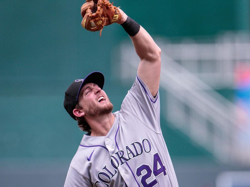 Jun 4, 2023; Kansas City, Missouri, USA; Colorado Rockies third baseman Ryan McMahon (24) reaches for a pop fly during the seventh inning against the Kansas City Royals at Kauffman Stadium. Mandatory Credit: William Purnell-USA TODAY Sports