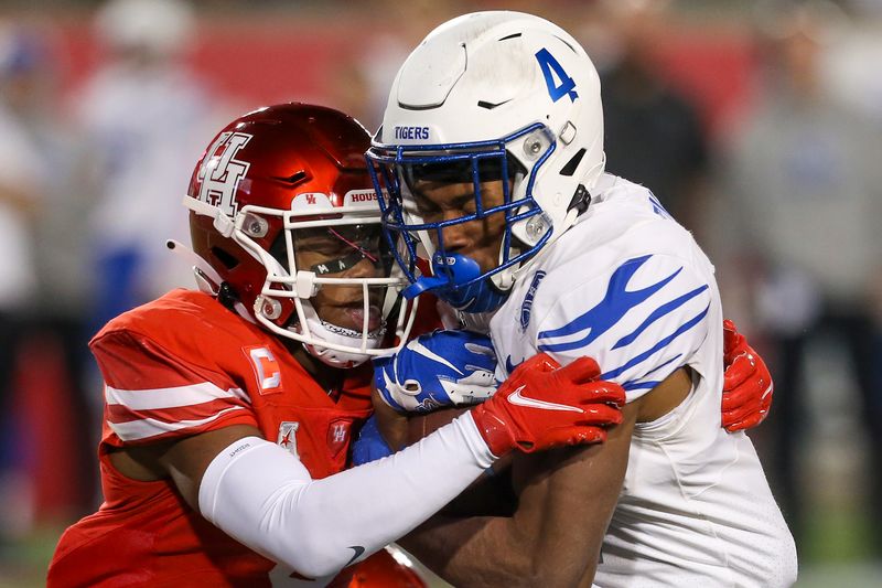 Nov 19, 2021; Houston, Texas, USA;  Memphis Tigers wide receiver Calvin Austin III (4) is tackled by Houston Cougars cornerback Marcus Jones (8) in the third quarter at TDECU Stadium. Houston Cougars won 31 to 13. Mandatory Credit: Thomas Shea-USA TODAY Sports