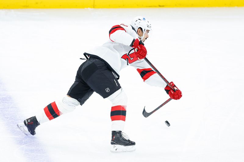 Nov 12, 2025; Chicago, Illinois, USA; New Jersey Devils defenseman Jonas Siegenthaler (71) shoots against the Chicago Blackhawks during the first period at United Center. Mandatory Credit: Kamil Krzaczynski-Imagn Images