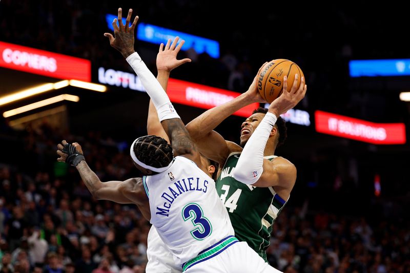 MINNEAPOLIS, MINNESOTA - FEBRUARY 23: Giannis Antetokounmpo #34 of the Milwaukee Bucks is fouled by Jaden McDaniels #3 of the Minnesota Timberwolves in the fourth quarter at Target Center on February 23, 2024 in Minneapolis, Minnesota. The Bucks defeated the Timberwolves 112-107. NOTE TO USER: User expressly acknowledges and agrees that, by downloading and or using this photograph, User is consenting to the terms and conditions of the Getty Images License Agreement. (Photo by David Berding/Getty Images)