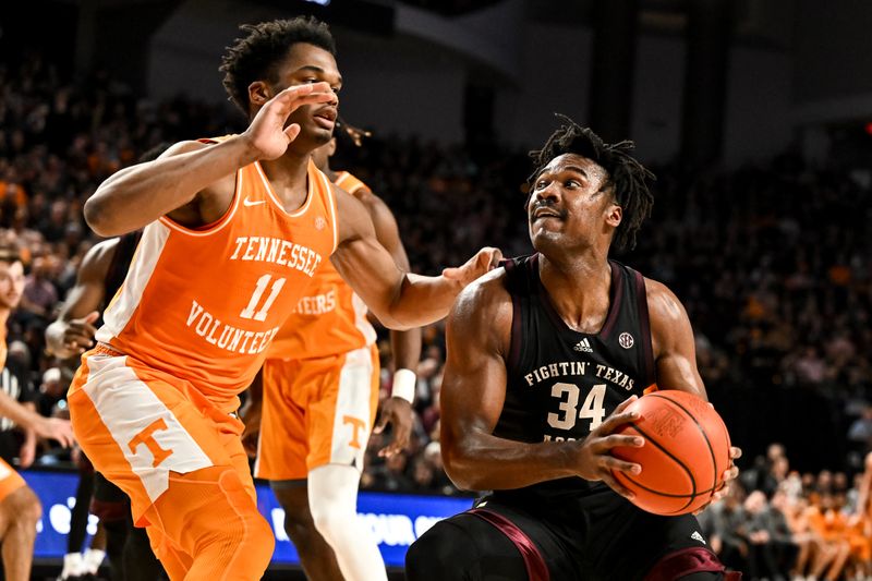 Feb 21, 2023; College Station, Texas, USA;  Texas A&M Aggies forward Julius Marble (34) drives to the basket against Tennessee Volunteers forward Tobe Awaka (11) during the second half at Reed Arena. Mandatory Credit: Maria Lysaker-USA TODAY Sports