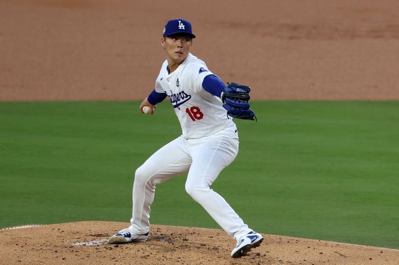 Oct 26, 2024; Los Angeles, California, USA; Los Angeles Dodgers pitcher Yoshinobu Yamamoto (18) throws a pitchl against the New York Yankees in the first inning for game two of the 2024 MLB World Series at Dodger Stadium. Mandatory Credit: Kiyoshi Mio-Imagn Images