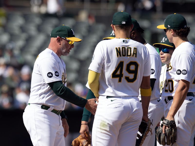 Sep 23, 2023; Oakland, California, USA; Oakland Athletics manager Mark Kotsay (left) makes a pitching change against the Detroit Tigers during the eighth inning at Oakland-Alameda County Coliseum. Mandatory Credit: D. Ross Cameron-USA TODAY Sports