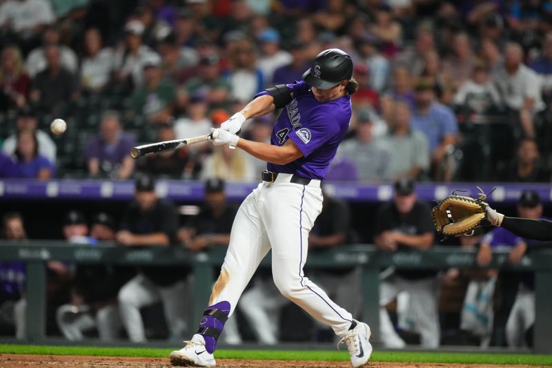 Jul 19, 2024; Denver, Colorado, USA; Colorado Rockies first base Michael Toglia (4) doubles in the eighth inning against the San Francisco Giants at Coors Field. Mandatory Credit: Ron Chenoy-USA TODAY Sports