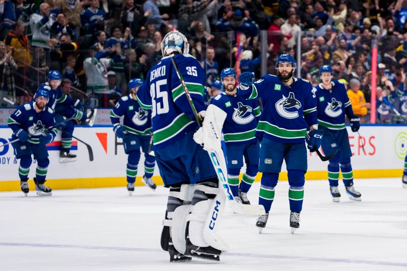 Nov 15, 2023; Vancouver, British Columbia, CAN;  Vancouver Canucks forward Phillip Di Giuseppe (34) and goalie Thatcher Demko (35) celebrate after defeating the New York Islanders at Rogers Arena. Vancouver won 4-3 in overtime. Mandatory Credit: Bob Frid-USA TODAY Sports