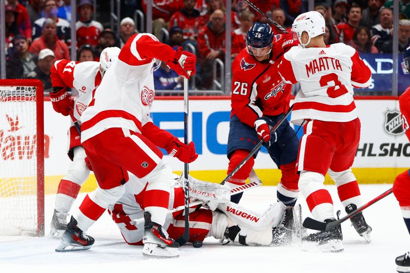 Mar 26, 2024; Washington, District of Columbia, USA; Washington Capitals right wing Nic Dowd (26) battles for the puck with Detroit Red Wings goaltender Alex Lyon (34) and Red Wings center Dylan Larkin (71) during the first period at Capital One Arena. Mandatory Credit: Amber Searls-USA TODAY Sports