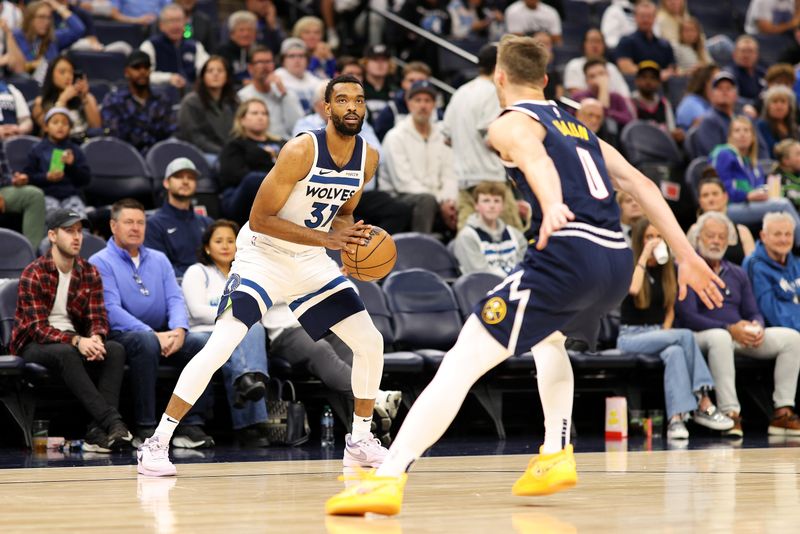 MINNEAPOLIS, MINNESOTA - OCTOBER 17: Keita Bates-Diop #31 of the Minnesota Timberwolves handles the ball against Christian Braun #0 of the Denver Nuggets in the first quarter of a preseason game at Target Center on October 17, 2024 in Minneapolis, Minnesota. NOTE TO USER: User expressly acknowledges and agrees that, by downloading and or using this photograph, User is consenting to the terms and conditions of the Getty Images License Agreement. (Photo by David Berding/Getty Images)