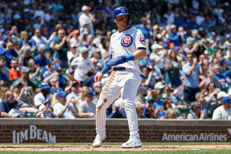 May 5, 2023; Chicago, Illinois, USA; Chicago Cubs second baseman Nico Hoerner (2) scores against the Miami Marlins during the first inning at Wrigley Field. Mandatory Credit: Kamil Krzaczynski-USA TODAY Sports