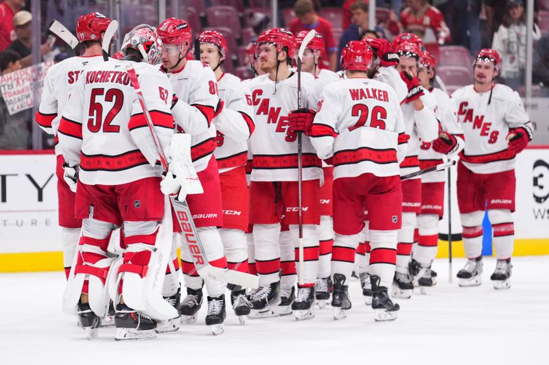 Jan 2, 2025; Sunrise, Florida, USA; Carolina Hurricanes goaltender Pyotr Kochetkov (52) is congrulted by teammtes after defeating the Florida Panthers at Amerant Bank Arena. Mandatory Credit: Rich Storry-Imagn Images