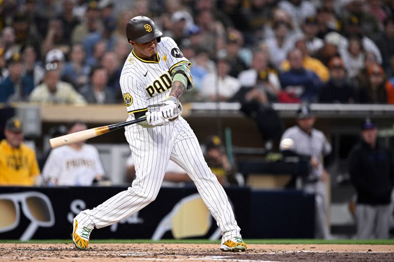 May 13, 2024; San Diego, California, USA; San Diego Padres third baseman Manny Machado (13) hits a single against the Colorado Rockies during the fourth inning at Petco Park. Mandatory Credit: Orlando Ramirez-USA TODAY Sports