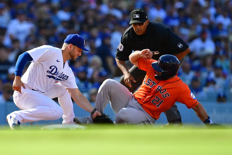 Jun 24, 2023; Los Angeles, California, USA; Houston Astros catcher Yainer Diaz (21) is out at third against the tag of Los Angeles Dodgers third baseman Michael Busch (83) during the fourth inning at Dodger Stadium. Mandatory Credit: Gary A. Vasquez-USA TODAY Sports