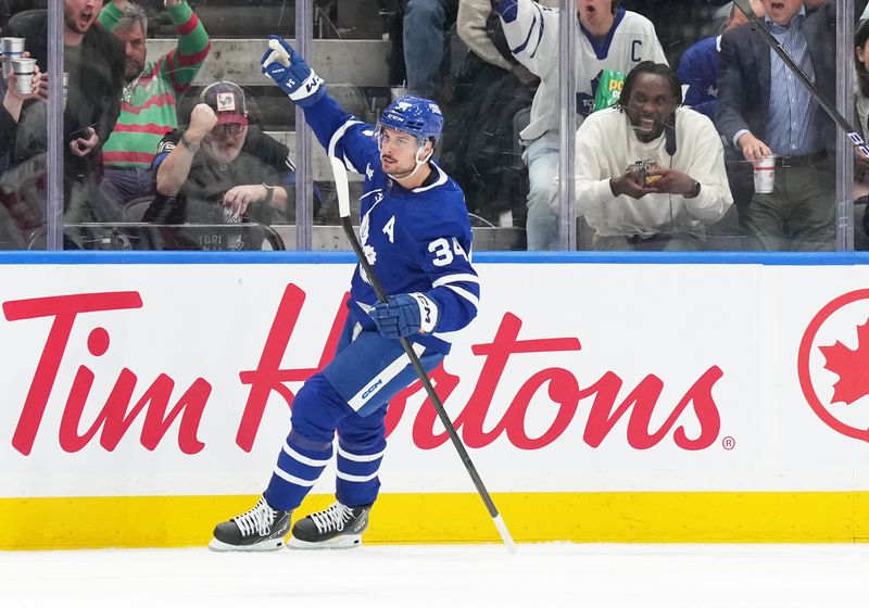 Mar 26, 2024; Toronto, Ontario, CAN; Toronto Maple Leafs center Auston Matthews (34) celebrates scoring a goal against the New Jersey Devils during the second period at Scotiabank Arena. Mandatory Credit: Nick Turchiaro-USA TODAY Sports