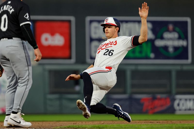 Apr 24, 2024; Minneapolis, Minnesota, USA; Minnesota Twins right fielder Max Kepler (26) slides into third base on a single by catcher Christian Vazquez (not pictured) against the Chicago White Sox in the fifth inning at Target Field. Mandatory Credit: Bruce Kluckhohn-USA TODAY Sports