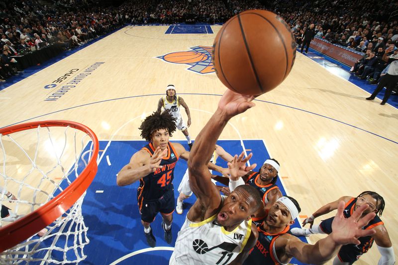 NEW YORK, NY - JANUARY 30: Kris Dunn #11 of the Utah Jazz rebounds the ball during the game against the New York Knicks on January 30, 2024 at Madison Square Garden in New York City, New York.  NOTE TO USER: User expressly acknowledges and agrees that, by downloading and or using this photograph, User is consenting to the terms and conditions of the Getty Images License Agreement. Mandatory Copyright Notice: Copyright 2024 NBAE  (Photo by Nathaniel S. Butler/NBAE via Getty Images)