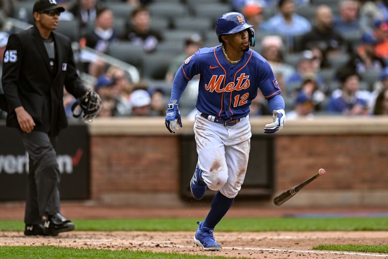 Jun 4, 2023; New York City, New York, USA; New York Mets shortstop Francisco Lindor (12) hits a single against the Toronto Blue Jays during the third inning at Citi Field. Mandatory Credit: John Jones-USA TODAY Sports