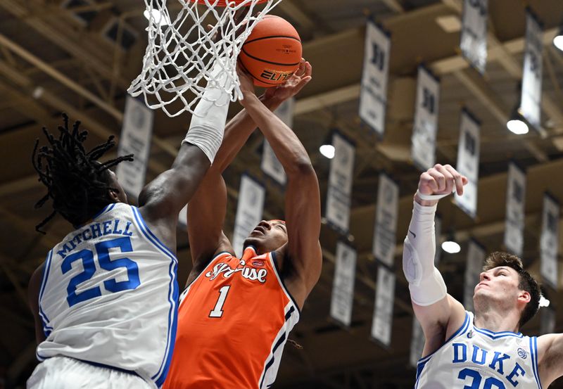 Jan 2, 2024; Durham, North Carolina, USA;  Duke Blue Devils forward Mark Mitchell (25) blocks the shot of Syracuse Orange forward Maliq Brown (1) during the first half at Cameron Indoor Stadium. Mandatory Credit: Rob Kinnan-USA TODAY Sports