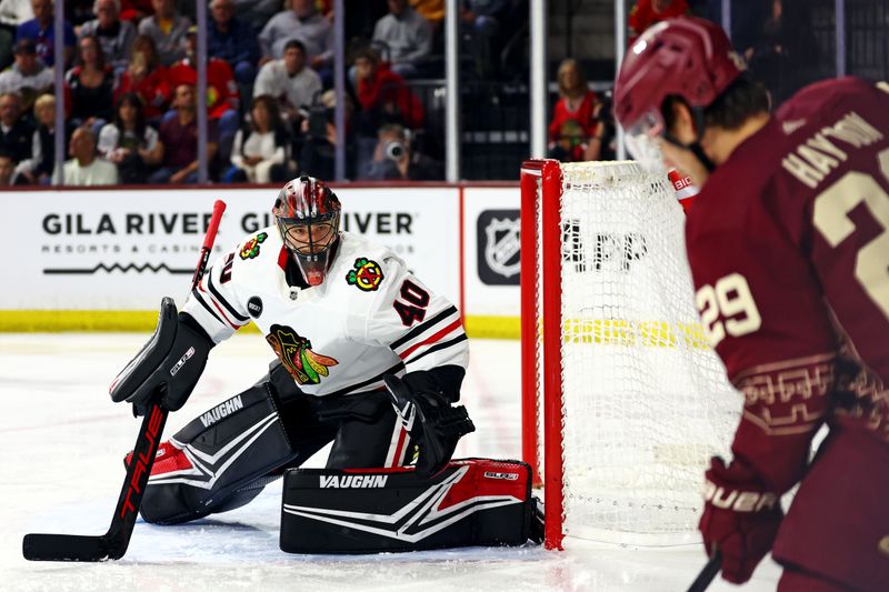 Mar 5, 2024; Tempe, Arizona, USA;  Chicago Blackhawks goaltender Arvid Soderblom (40) defends his goal against Arizona Coyotes center Barrett Hayton (29) during the second period at Mullett Arena. Mandatory Credit: Mark J. Rebilas-USA TODAY Sports