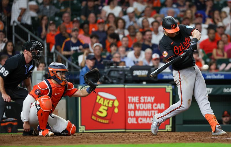 Jun 21, 2024; Houston, Texas, USA; Baltimore Orioles first baseman Ryan Mountcastle (6) hits a RBI single against then Houston Astros in the eighth inning at Minute Maid Park. Mandatory Credit: Thomas Shea-USA TODAY Sports