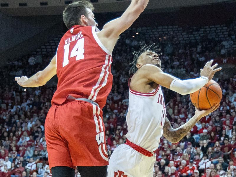 Jan 14, 2023; Bloomington, Indiana, USA; Indiana Hoosiers guard CJ Gunn (11) shoots the ball while Wisconsin Badgers forward Carter Gilmore (14) defends in the first half at Simon Skjodt Assembly Hall. Mandatory Credit: Trevor Ruszkowski-USA TODAY Sports