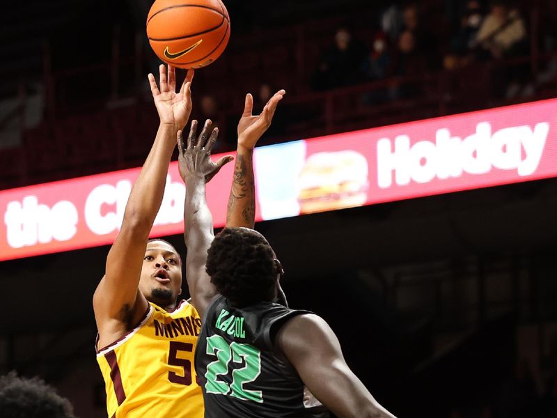 Dec 22, 2022; Minneapolis, Minnesota, USA; Minnesota Golden Gophers guard Ta'lon Cooper (55) shoots while Chicago State Cougars forward Arol Kacuol (22) defends during the first half at Williams Arena. Mandatory Credit: Matt Krohn-USA TODAY Sports