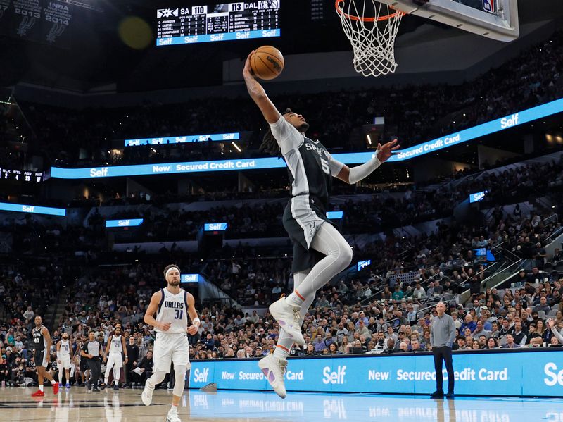 SAN ANTONIO, TX - MARCH 10:  Stephon Castle #5 of the San Antonio Spurs dunks against the Dallas Mavericks in the second half at Frost Bank Center on March 10, 2025 in San Antonio, Texas. NOTE TO USER: User expressly acknowledges and agrees that, by downloading and or using this photograph, User is consenting to terms and conditions of the Getty Images License Agreement. (Photo by Ronald Cortes/Getty Images)