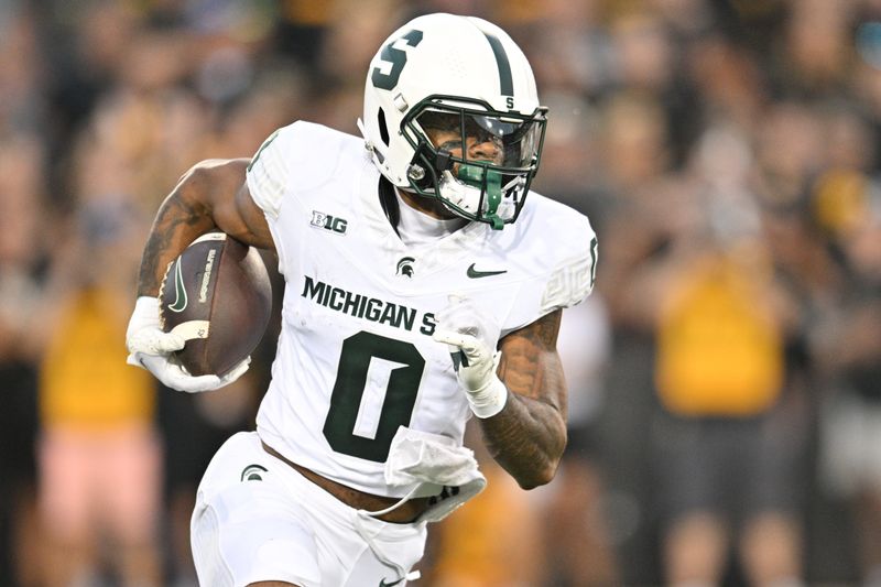 Sep 30, 2023; Iowa City, Iowa, USA; Michigan State Spartans wide receiver Alante Brown (0) runs the ball on a reverse during the first quarter against the Iowa Hawkeyes at Kinnick Stadium. Mandatory Credit: Jeffrey Becker-USA TODAY Sports