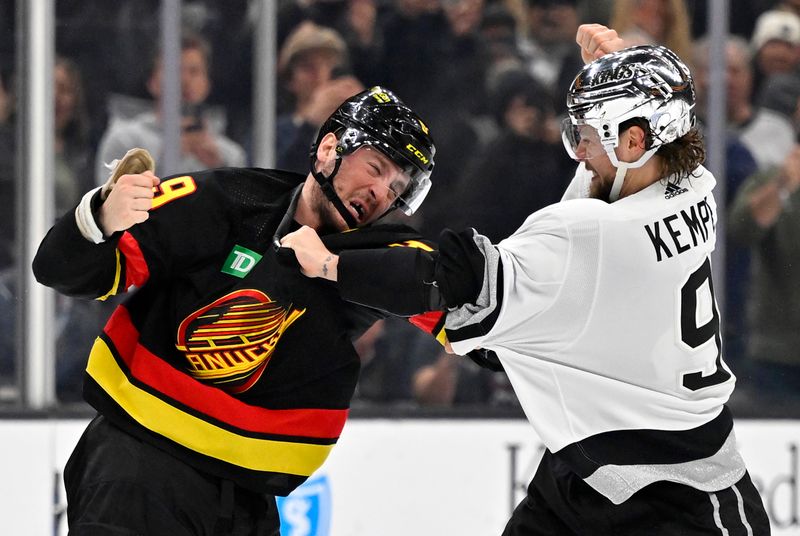 Apr 10, 2023; Los Angeles, California, USA;  Vancouver Canucks center J.T. Miller (9) and Los Angeles Kings right wing Adrian Kempe (9) fight in the second period at Crypto.com Arena. Mandatory Credit: Jayne Kamin-Oncea-USA TODAY Sports