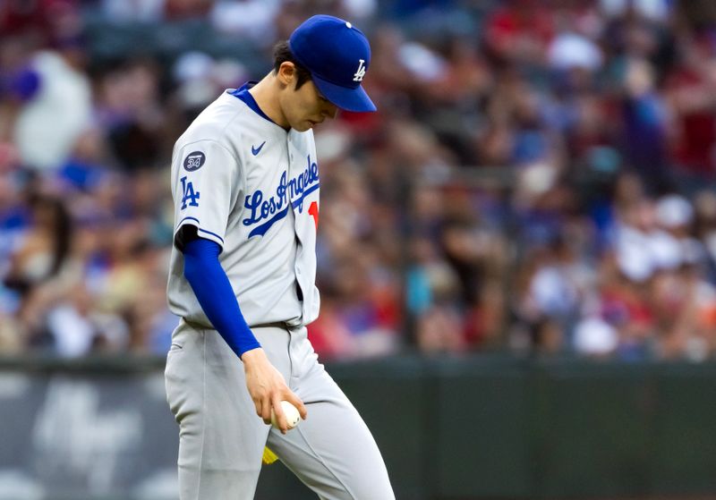 May 9, 2025; Phoenix, Arizona, USA; Los Angeles Dodgers pitcher Roki Sasaki reacts after giving up a home run to the Arizona Diamondbacks in the first inning at Chase Field. Mandatory Credit: Mark J. Rebilas-Imagn Images