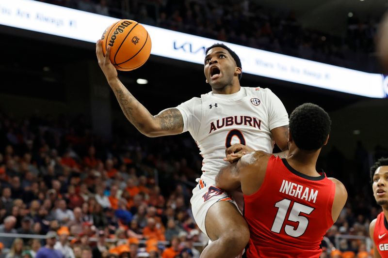 Feb 1, 2023; Auburn, Alabama, USA;  Auburn Tigers guard K.D. Johnson (0) goes against Georgia Bulldogs forward Jailyn Ingram (15) for a shot during the second half at Neville Arena. Mandatory Credit: John Reed-USA TODAY Sports