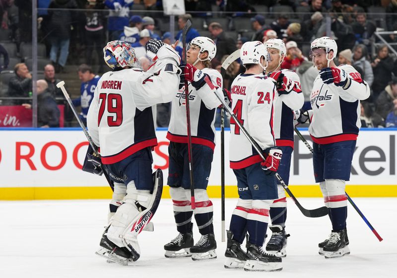 Dec 6, 2024; Toronto, Ontario, CAN; Washington Capitals defenseman Jakob Chychrun (6) celebrates the win with goaltender Charlie Lindgren (79) against the Toronto Maple Leafs at the end of the third period at Scotiabank Arena. Mandatory Credit: Nick Turchiaro-Imagn Images
