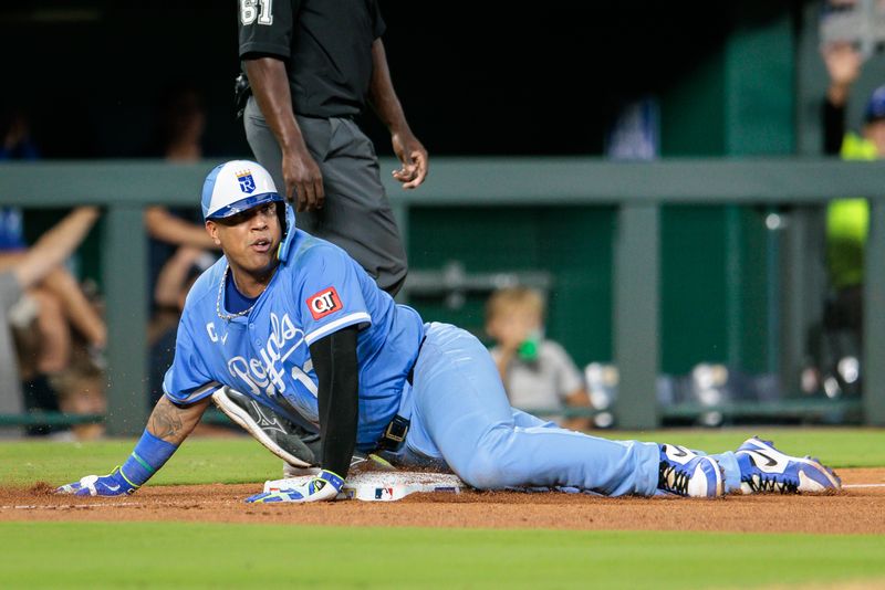 Sep 20, 2025; Kansas City, Missouri, USA; Kansas City Royals catcher Salvador Perez (13) slides into third base during the seventh inning against the Toronto Blue Jays at Kauffman Stadium. Mandatory Credit: William Purnell-Imagn Images