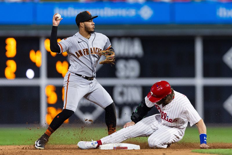 Aug 22, 2023; Philadelphia, Pennsylvania, USA; San Francisco Giants second baseman Thairo Estrada (39) throws for a double play after tagging out Philadelphia Phillies designated hitter Bryce Harper (3) during the eighth inning at Citizens Bank Park. Mandatory Credit: Bill Streicher-USA TODAY Sports