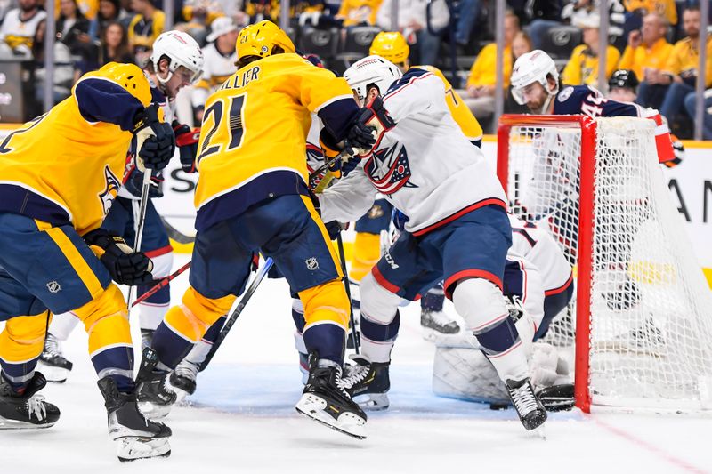 Apr 13, 2024; Nashville, Tennessee, USA; Columbus Blue Jackets goaltender Jet Greaves (73) blocks the shot of Nashville Predators left wing Anthony Beauvillier (21) during the third period at Bridgestone Arena. Mandatory Credit: Steve Roberts-USA TODAY Sports