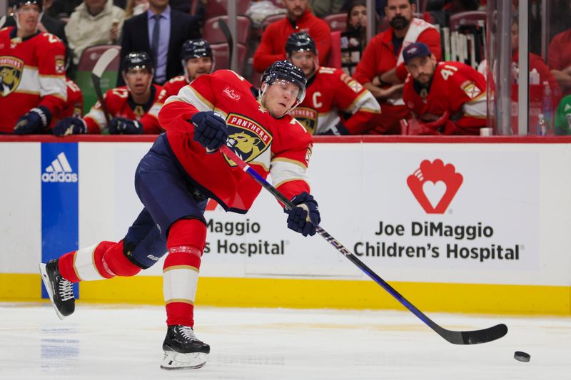 Nov 24, 2023; Sunrise, Florida, USA; Florida Panthers defenseman Niko Mikkola (77) shoots the puck against the Winnipeg Jets during the second period at Amerant Bank Arena. Mandatory Credit: Sam Navarro-USA TODAY Sports