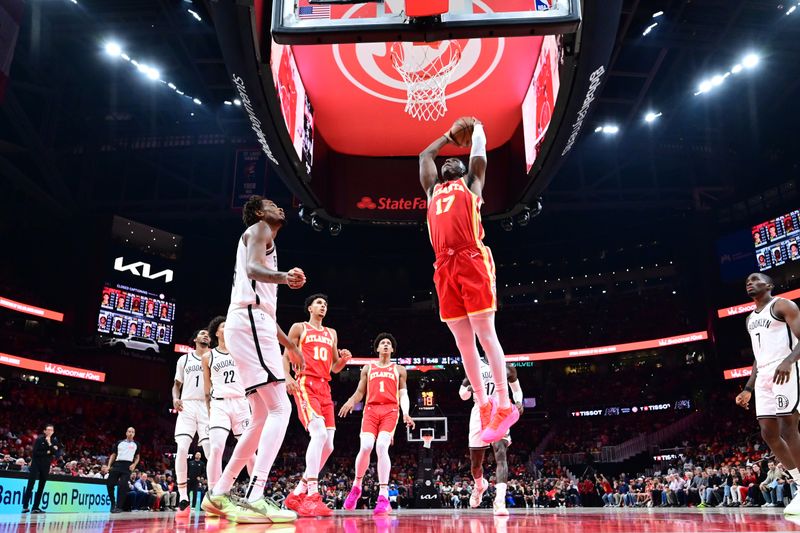 ATLANTA, GA - OCTOBER 23:  Onyeka Okongwu #17 of the Atlanta Hawks dunks the ball during the game against the Brooklyn Nets on October 23, 2024 at State Farm Arena in Atlanta, Georgia.  NOTE TO USER: User expressly acknowledges and agrees that, by downloading and/or using this Photograph, user is consenting to the terms and conditions of the Getty Images License Agreement. Mandatory Copyright Notice: Copyright 2024 NBAE (Photo by Adam Hagy/NBAE via Getty Images)