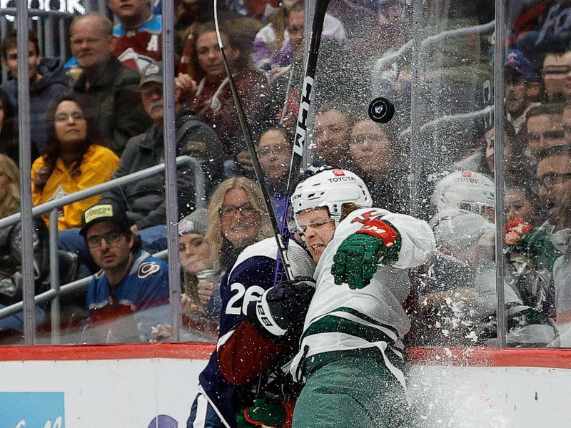 Mar 8, 2024; Denver, Colorado, USA; Colorado Avalanche defenseman Sean Walker (26) checks Minnesota Wild center Mason Shaw (15) into the boards in the first period at Ball Arena. Mandatory Credit: Isaiah J. Downing-USA TODAY Sports